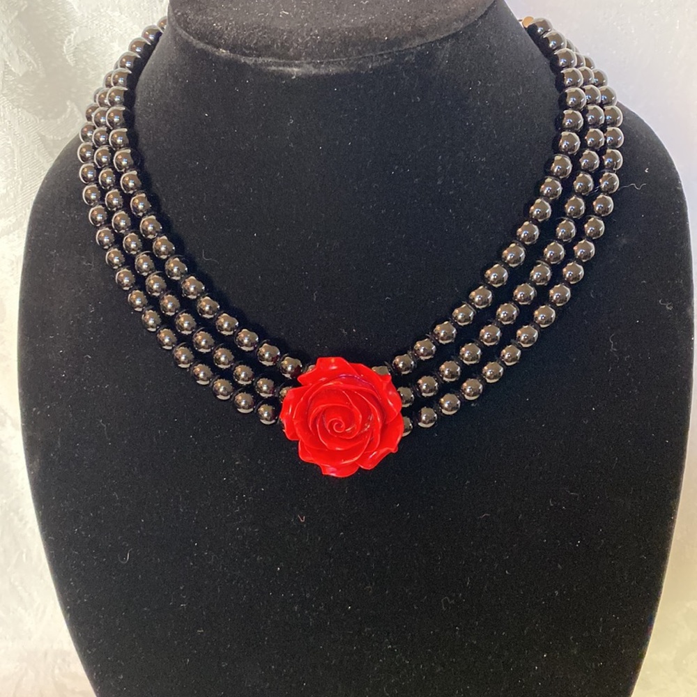 Cute red rose necklace with 3 strands of black beads. Adjustable perfect cond.